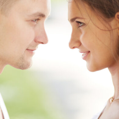 A couple stands facing each other in a quiet, reflective moment, suggesting connection, tension, and the balance between distance and intimacy.