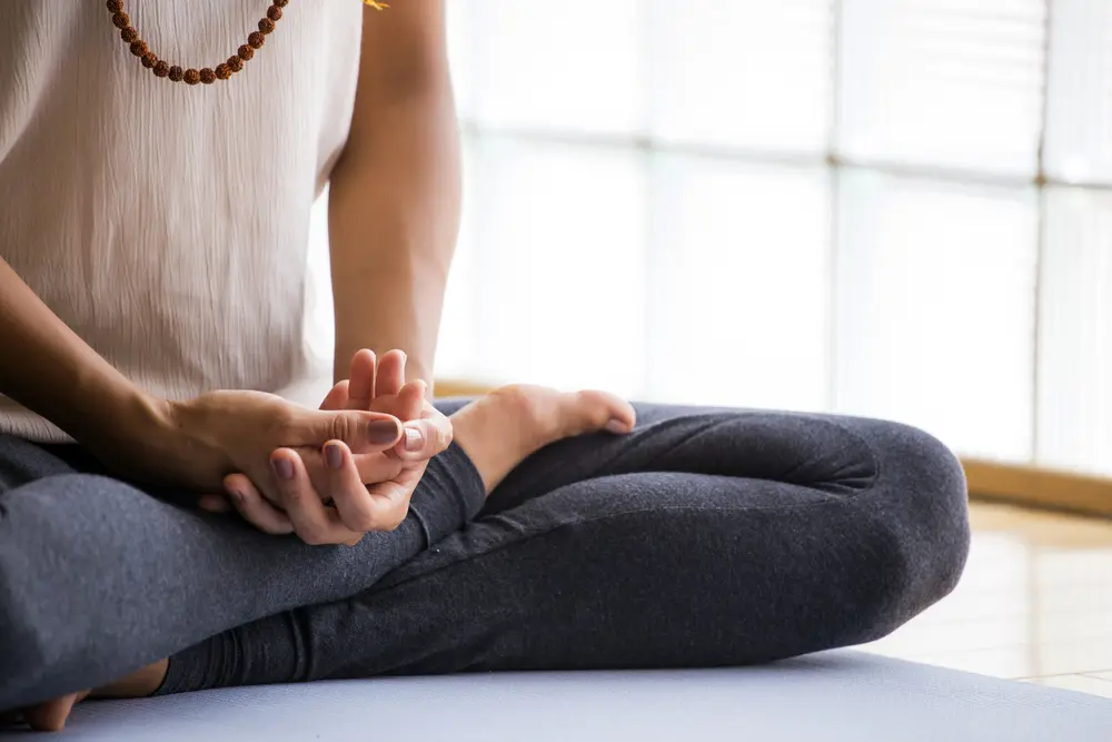 Woman practicing meditation in a calm setting as part of Ayurveda wellness routine in Ottawa supporting mental clarity and emotional balance